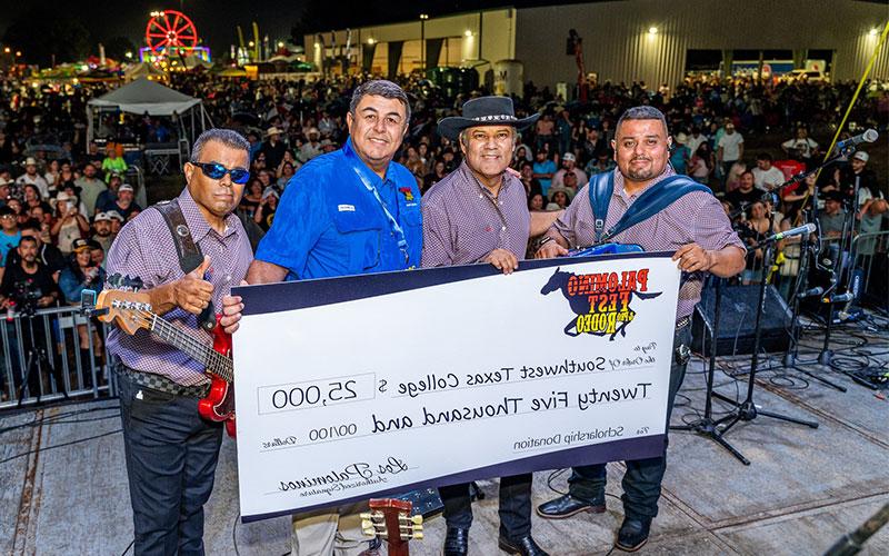 Photo of SWTX President Hector Gonzales with members of Los Palominos posing with a donation check for $25,000 to be used towards scholarships.